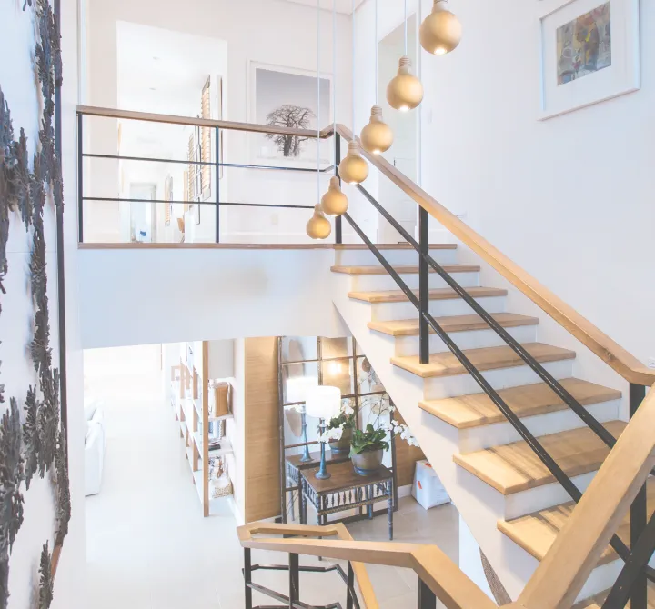 An open staircase and mezzanine in a bright residential interior.