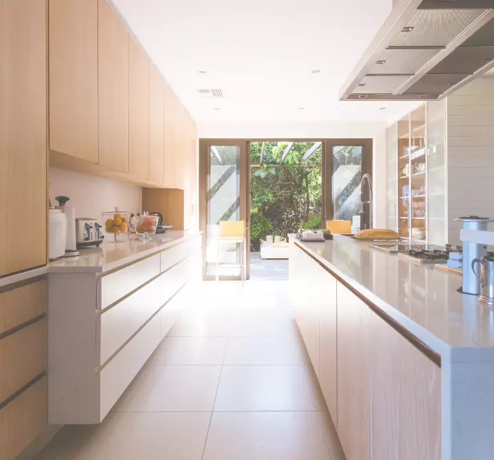 A galley kitchen opening onto a garden terrace.
